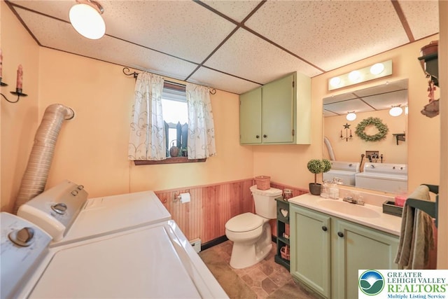 70 Faust N Rd, Pa, PA 19507 - bathroom with washing machine and clothes dryer, a drop ceiling, vanity, a wainscoted wall, and wooden walls