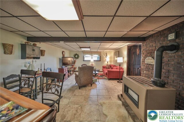 70 Faust N Rd, Pa, PA 19507 - living area featuring a drop ceiling, a wood stove, and brick wall