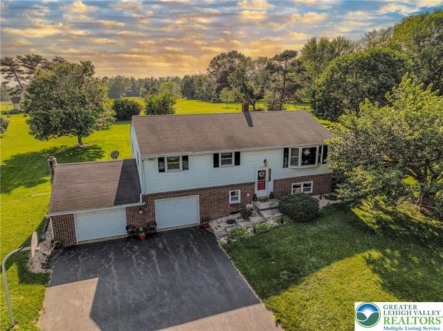 70 Faust N Rd, Pa, PA 19507 - view of front of house featuring brick siding, a yard, driveway, and view of scattered trees