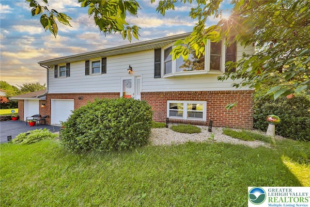 70 Faust N Rd, Pa, PA 19507 - raised ranch with brick siding, a garage, driveway, and a yard