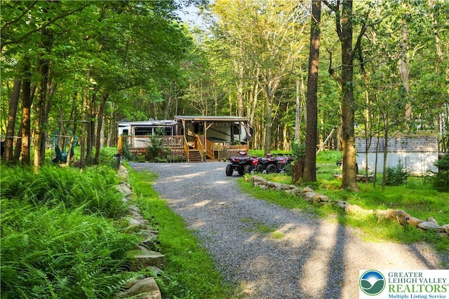 149 Deer Path Ln, Tobyhanna Twp, PA 18346 - view of front of property with a wooden deck and a forest view