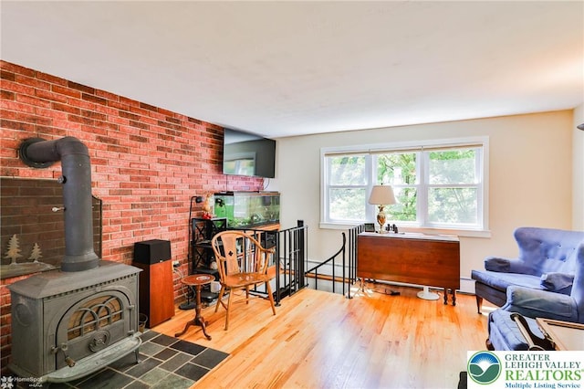 388 Kohls Rd, Allen Twp, PA 18067 - living room featuring wood finished floors, a wood stove, and a baseboard radiator
