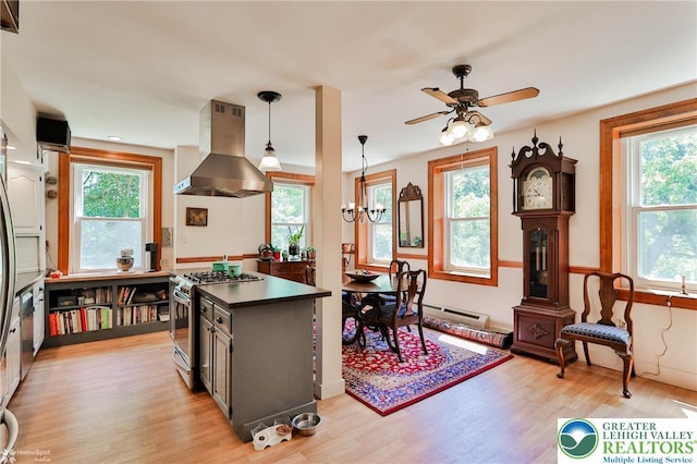 388 Kohls Rd, Allen Twp, PA 18067 - kitchen with stainless steel range with gas stovetop, island exhaust hood, dark countertops, light wood finished floors, and ceiling fan