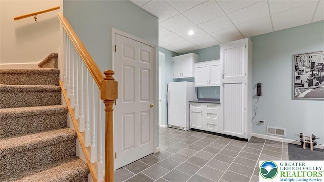 310 Spyglass Hill Rd, Bath Boro, PA 18014 - kitchen featuring freestanding refrigerator, white cabinetry, dark tile patterned flooring, a drop ceiling, and recessed lighting