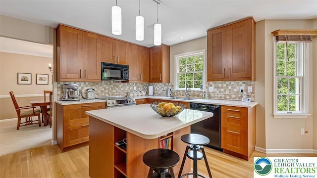 310 Spyglass Hill Rd, Bath Boro, PA 18014 - kitchen featuring black appliances, light wood-style floors, light countertops, brown cabinets, and decorative backsplash