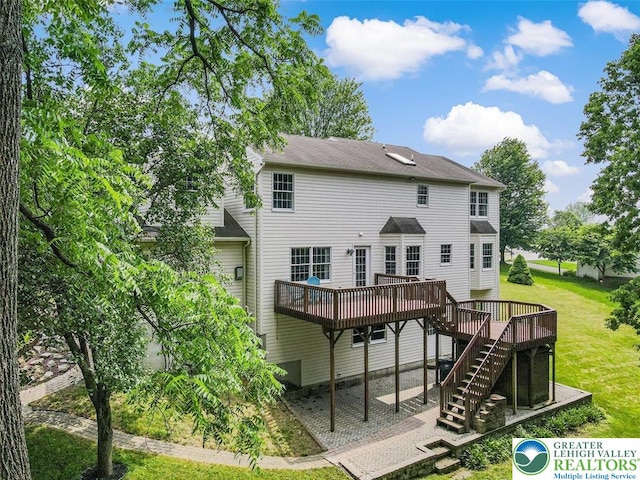 310 Spyglass Hill Rd, Bath Boro, PA 18014 - rear view of house with a deck, stairway, and a lawn