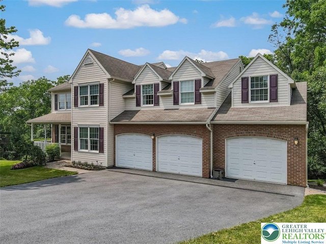 310 Spyglass Hill Rd, Bath Boro, PA 18014 - view of front of house featuring driveway, brick siding, an attached garage, and a shingled roof