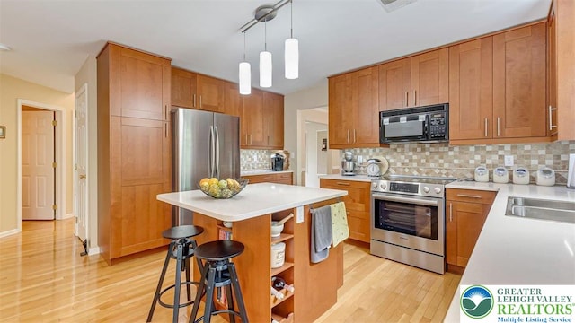310 Spyglass Hill Rd, Bath Boro, PA 18014 - kitchen with stainless steel appliances, open shelves, light wood finished floors, and a kitchen island