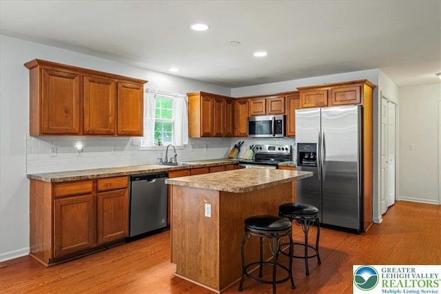 210 Swartsburo Dr, Lehman Twp, PA 18371 - kitchen with stainless steel appliances, wood finished floors, a center island, decorative backsplash, and recessed lighting