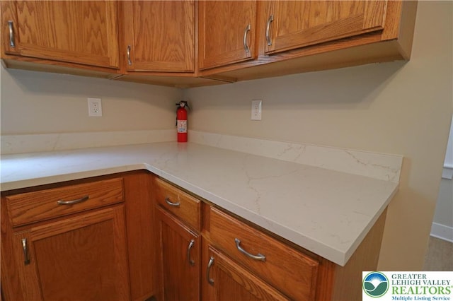 318 S Watson St, Palmer Twp, PA 18045 - kitchen featuring brown cabinets and light stone counters