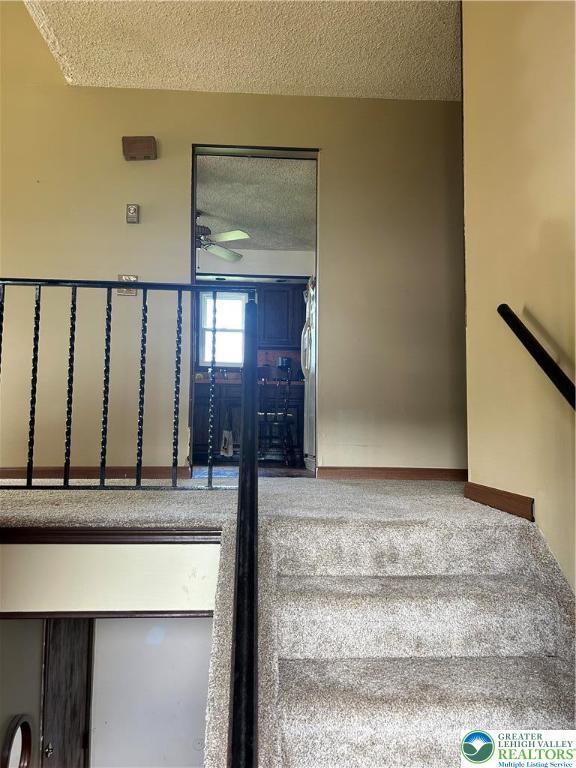 4103 Birch Dr, Bethlehem City, PA 18020 - stairway featuring a textured ceiling and ceiling fan