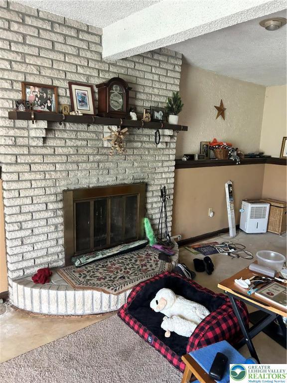 4103 Birch Dr, Bethlehem City, PA 18020 - living room featuring a textured ceiling and a fireplace