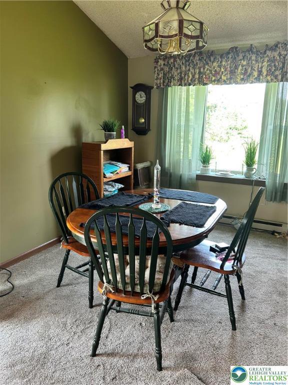 4103 Birch Dr, Bethlehem City, PA 18020 - dining space featuring a textured ceiling, carpet flooring, a chandelier, and lofted ceiling