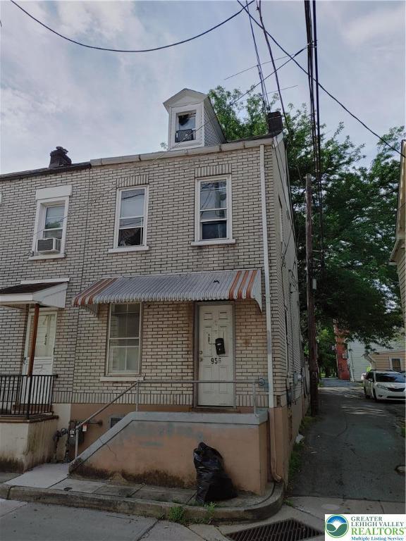 956 Oak St, Allentown City, PA 18102 - view of property with brick siding, a chimney, and cooling unit