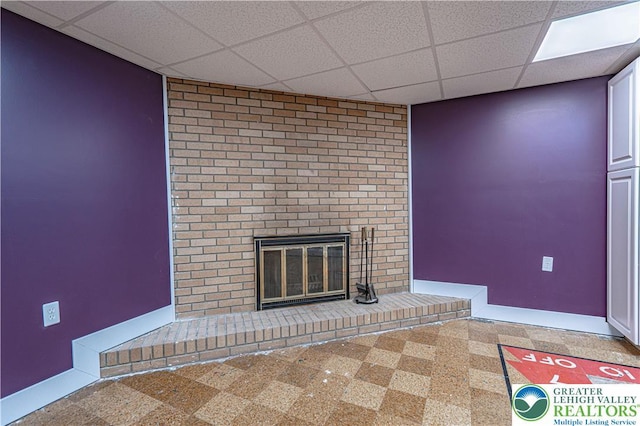 3442 Hickory Cir S, Whitehall Twp, PA 18103 - unfurnished living room featuring a paneled ceiling, a fireplace, and tile patterned floors
