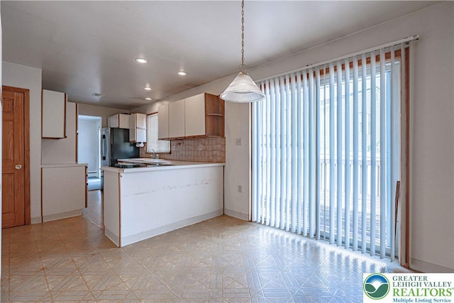3442 Hickory Cir S, Whitehall Twp, PA 18103 - kitchen with freestanding refrigerator, a peninsula, light flooring, white cabinets, and recessed lighting