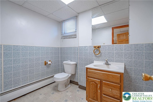 3442 Hickory Cir S, Whitehall Twp, PA 18103 - bathroom with a baseboard heating unit, vanity, tile walls, a paneled ceiling, and a wainscoted wall