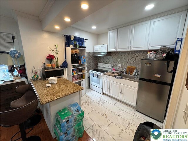 640 Park St, Allentown City, PA 18102 - kitchen featuring stainless steel appliances, ornamental molding, under cabinet range hood, white cabinets, and light marble finish flooring