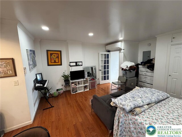 640 Park St, Allentown City, PA 18102 - bedroom featuring an AC wall unit, wood finished floors, electric panel, recessed lighting, and crown molding