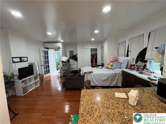 640 Park St, Allentown City, PA 18102 - bedroom with a wall unit AC, wood finished floors, recessed lighting, and a closet