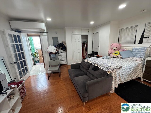 640 Park St, Allentown City, PA 18102 - bedroom featuring an AC wall unit, wood finished floors, ornamental molding, a closet, and recessed lighting