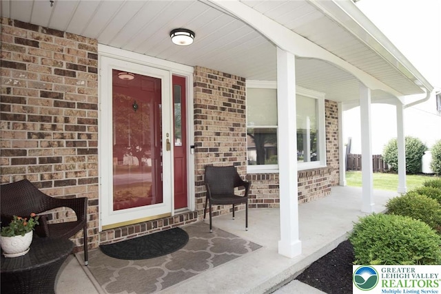 1325 Devon Cir S, Whitehall Twp, PA 18104 - view of exterior entry featuring covered porch and brick siding