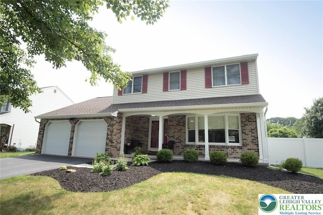 1325 Devon Cir S, Whitehall Twp, PA 18104 - traditional-style house featuring a porch, driveway, brick siding, and an attached garage