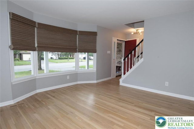 1325 Devon Cir S, Whitehall Twp, PA 18104 - unfurnished living room featuring light wood-style flooring, a chandelier, and stairs