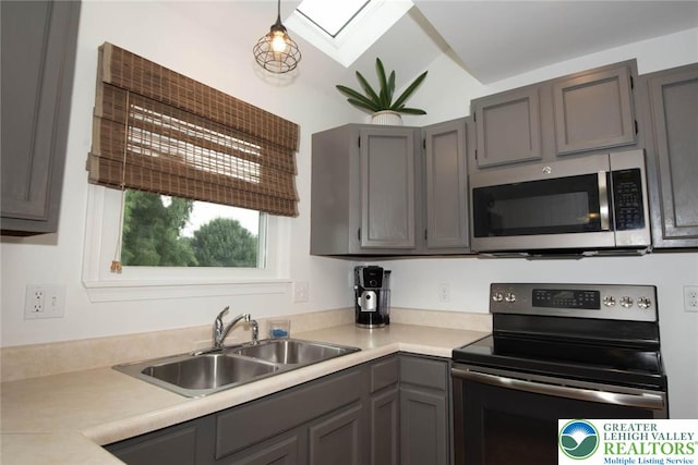 1325 Devon Cir S, Whitehall Twp, PA 18104 - kitchen featuring stainless steel appliances, a skylight, light countertops, and gray cabinets