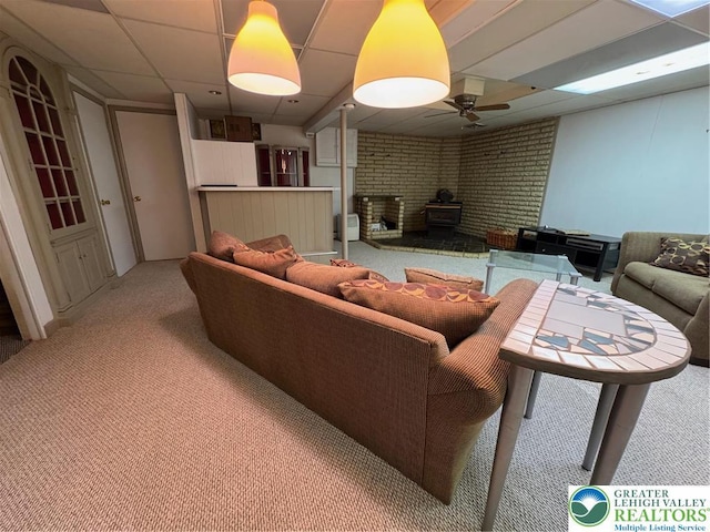2450 Levans Rd, Coplay Boro, PA 18037 - living area featuring light colored carpet, a ceiling fan, a wood stove, and a paneled ceiling