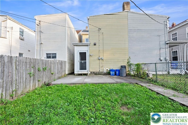 919 Lehigh St, Easton, PA 18042 - back of house featuring a patio, a fenced backyard, and a chimney