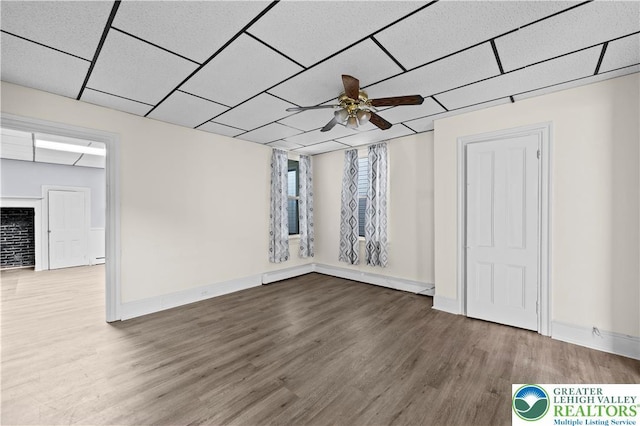 919 Lehigh St, Easton, PA 18042 - spare room featuring wood finished floors, ceiling fan, a paneled ceiling, and baseboard heating
