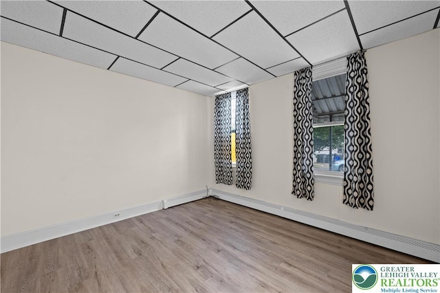 919 Lehigh St, Easton, PA 18042 - spare room with wood finished floors, a baseboard radiator, and a drop ceiling