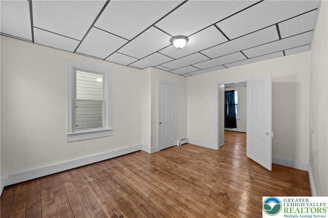 919 Lehigh St, Easton, PA 18042 - unfurnished room with baseboard heating, hardwood / wood-style flooring, and a paneled ceiling
