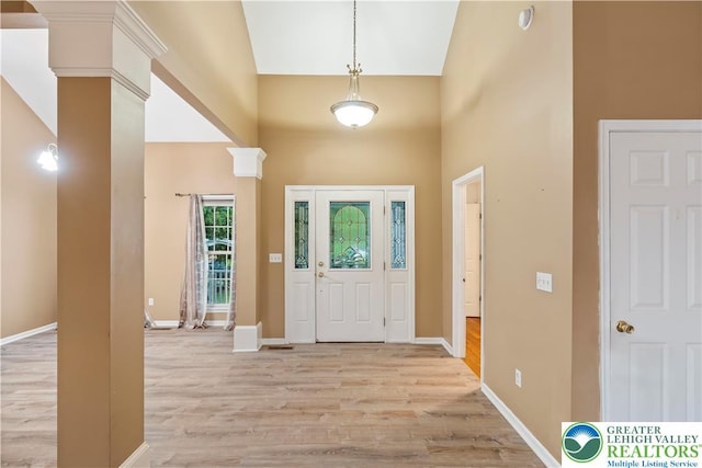 620 Pittston Ave, Luzerne, PA 18641 - entryway with high vaulted ceiling, light wood-style floors, and decorative columns
