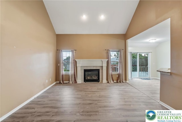 620 Pittston Ave, Luzerne, PA 18641 - unfurnished living room with high vaulted ceiling, a fireplace, and wood finished floors