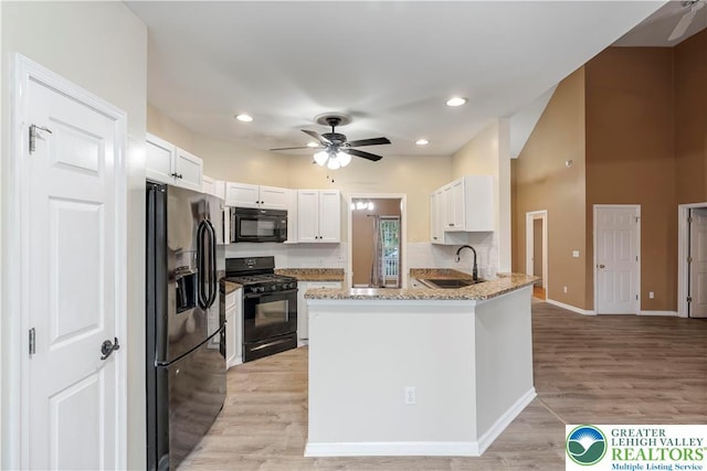 620 Pittston Ave, Luzerne, PA 18641 - kitchen featuring black appliances, ceiling fan, a peninsula, light stone counters, and white cabinets