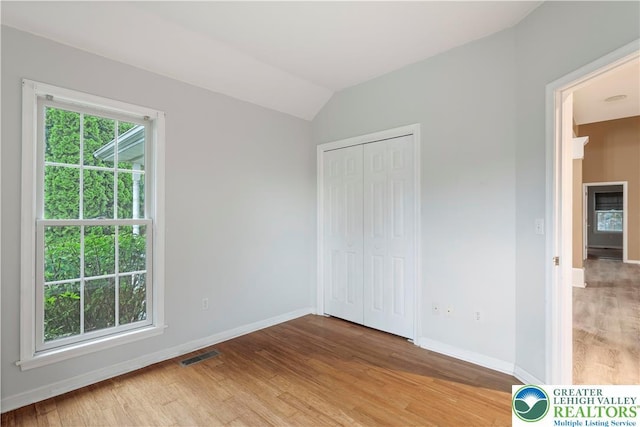620 Pittston Ave, Luzerne, PA 18641 - unfurnished bedroom featuring light wood-style flooring, lofted ceiling, and a closet
