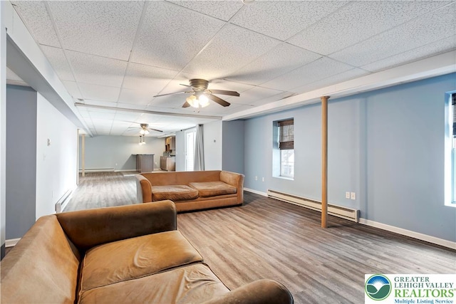 620 Pittston Ave, Luzerne, PA 18641 - living area featuring a baseboard radiator, ceiling fan, wood finished floors, a paneled ceiling, and baseboard heating