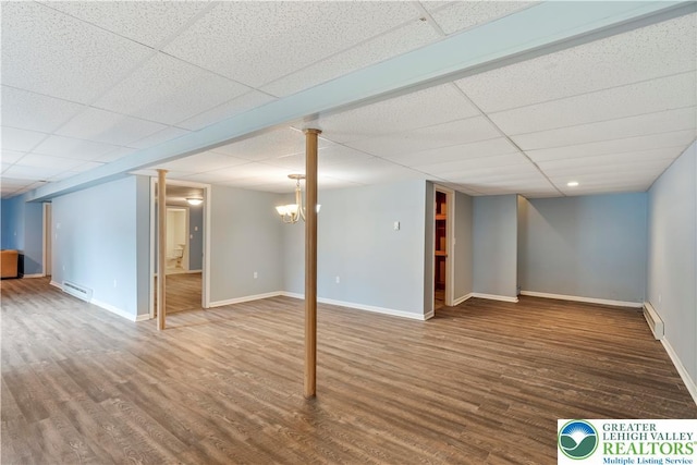 620 Pittston Ave, Luzerne, PA 18641 - finished below grade area featuring a baseboard heating unit, wood finished floors, and a drop ceiling