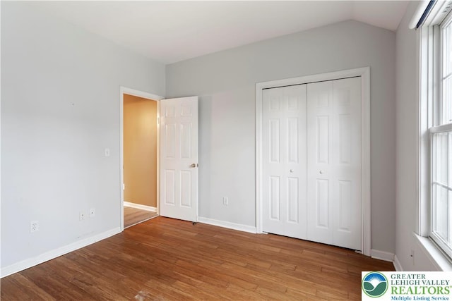 620 Pittston Ave, Luzerne, PA 18641 - unfurnished bedroom featuring wood finished floors, lofted ceiling, and a closet