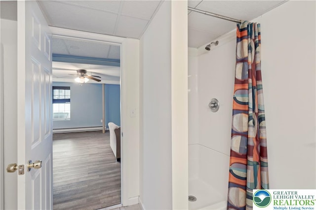 620 Pittston Ave, Luzerne, PA 18641 - bathroom featuring baseboard heating, a shower stall, ceiling fan, and wood finished floors