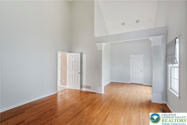 620 Pittston Ave, Luzerne, PA 18641 - empty room featuring a towering ceiling and light wood-style flooring