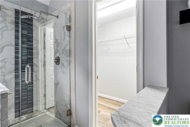 620 Pittston Ave, Luzerne, PA 18641 - full bathroom with a marble finish shower, a spacious closet, and wood finished floors