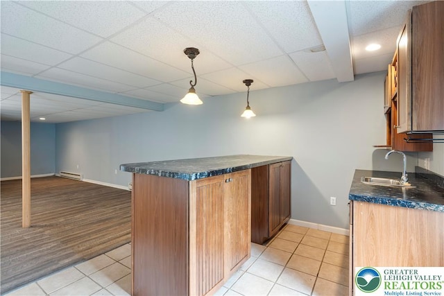 620 Pittston Ave, Luzerne, PA 18641 - kitchen with light tile patterned floors, brown cabinets, a peninsula, a drop ceiling, and hanging light fixtures