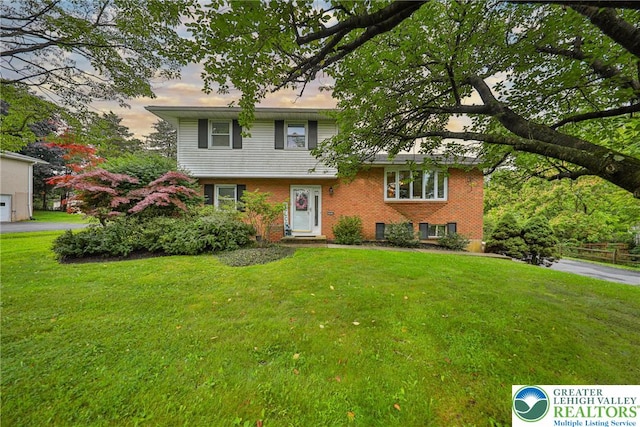 1812 Treeline Dr, Forks Twp, PA 18040 - view of front of property featuring a yard, brick siding, and a garage