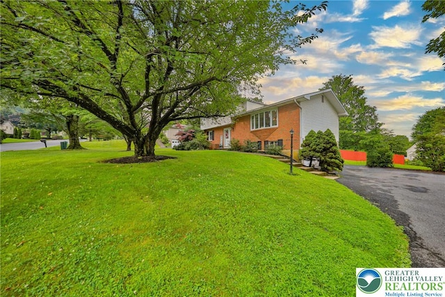 1812 Treeline Dr, Forks Twp, PA 18040 - view of front of home with a front yard, brick siding, and driveway