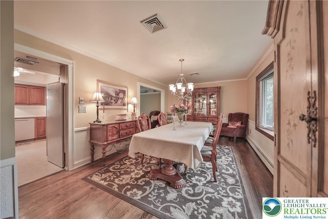 1812 Treeline Dr, Forks Twp, PA 18040 - dining room featuring a baseboard radiator, wood finished floors, a chandelier, and crown molding