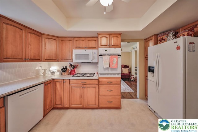 1812 Treeline Dr, Forks Twp, PA 18040 - kitchen with white appliances, a tray ceiling, brown cabinets, and ceiling fan