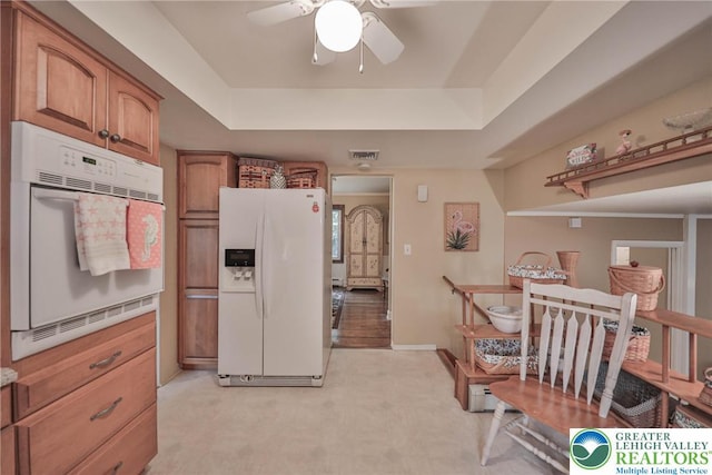 1812 Treeline Dr, Forks Twp, PA 18040 - kitchen with white appliances, a raised ceiling, ceiling fan, brown cabinets, and light carpet